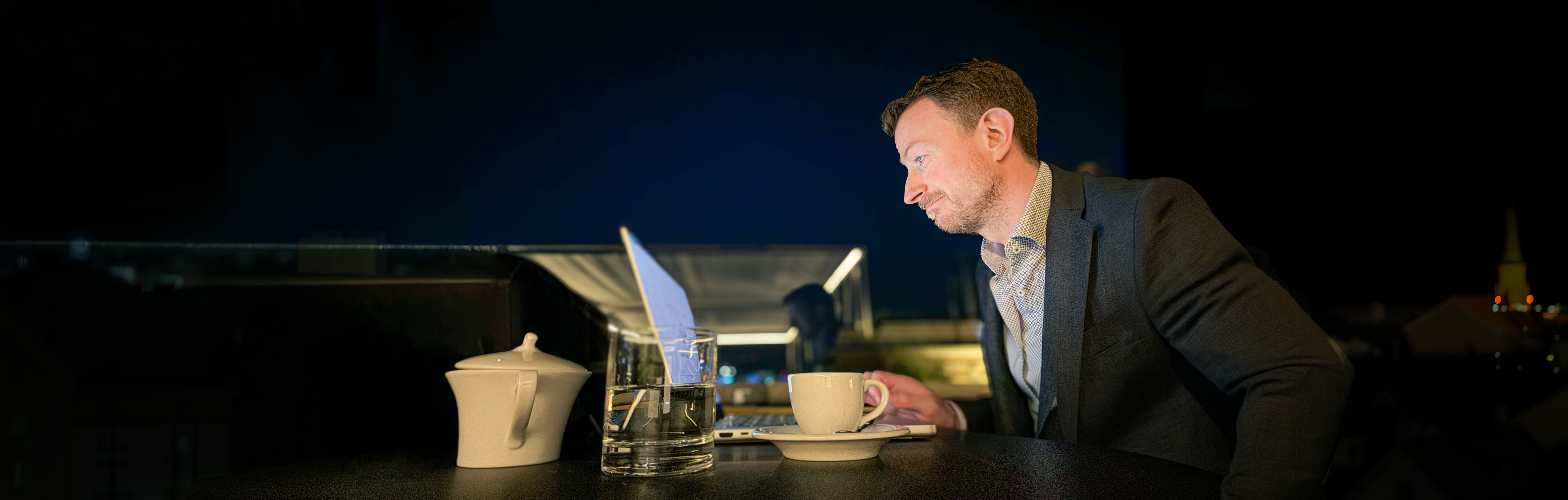 Richard Ulivella working on a rooftop terrace at night