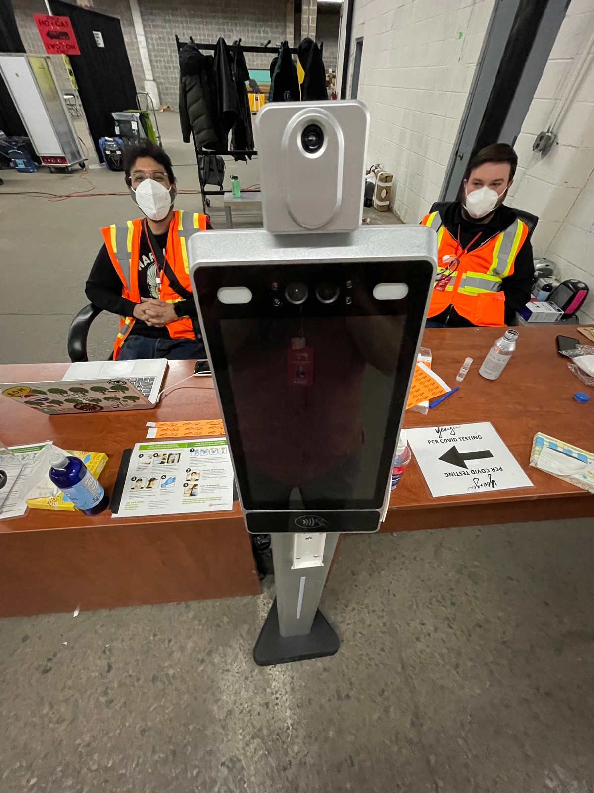 Crew in PPE at a COVID testing station with thermal scanner, Season Seven production