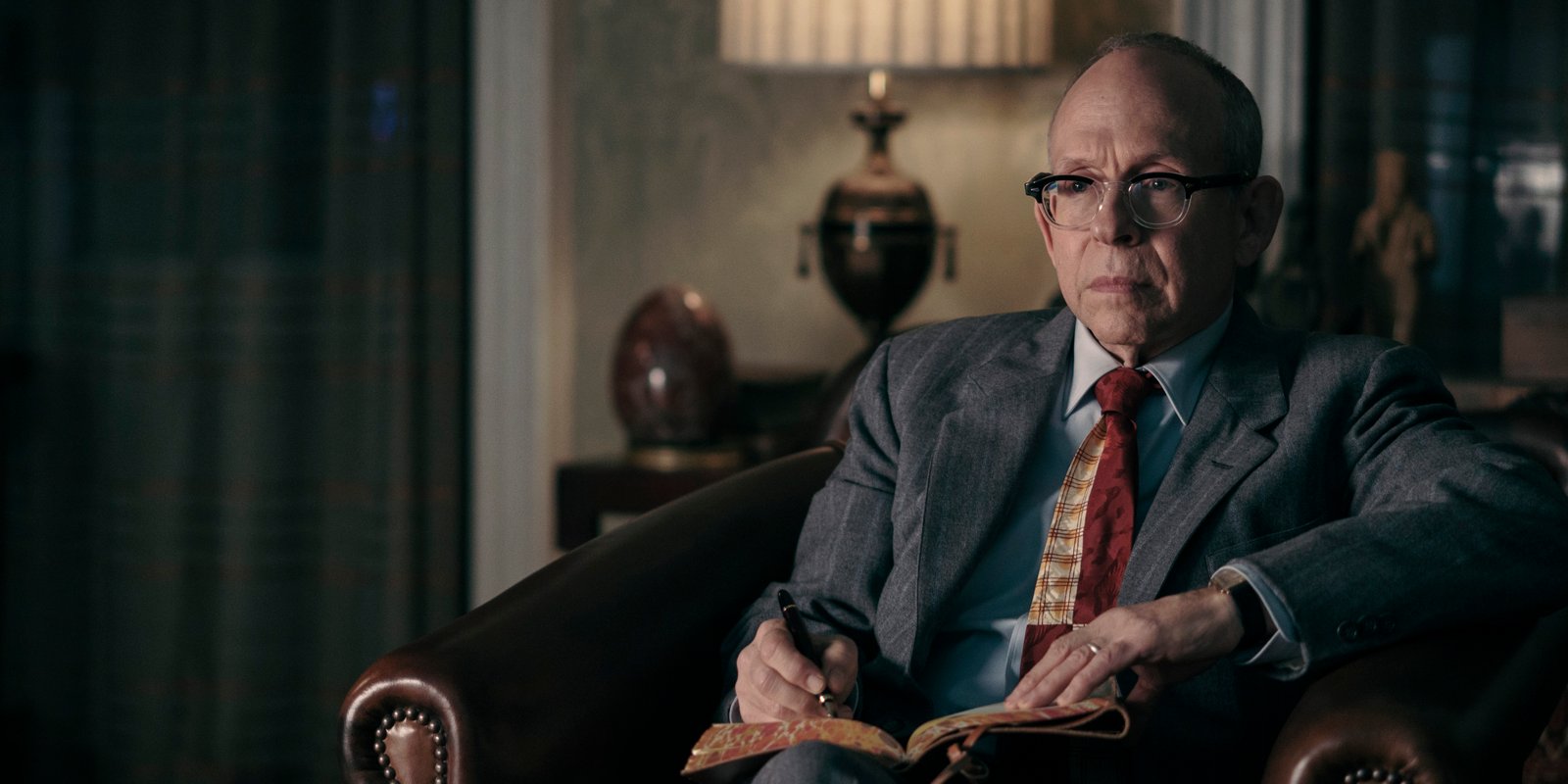 Bob Balaban in a period leather chair, interior — Wormwood