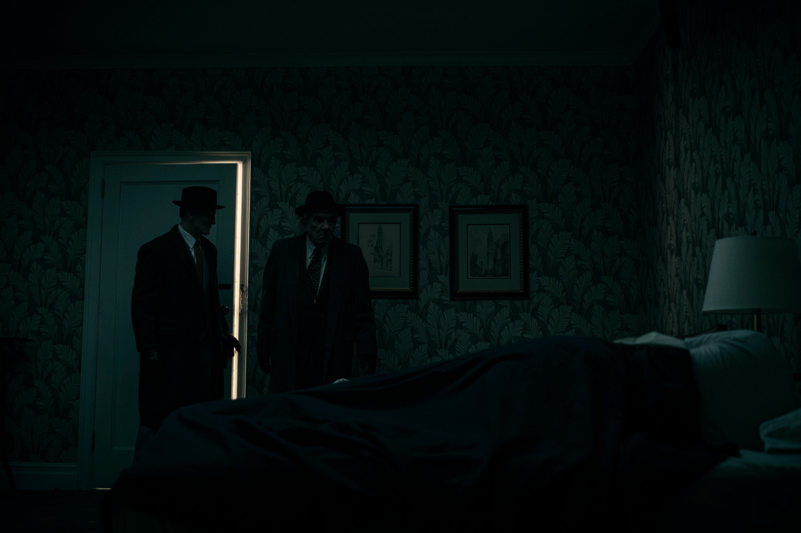 Two men in fedoras entering a dark hotel room — Wormwood